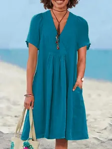 Stylish teal blue V-neck cotton linen summer dress with pleated detail and side pockets