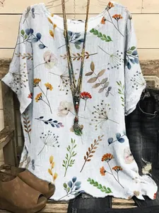 Detailed view of women's casual loose short-sleeved top with colorful botanical prints