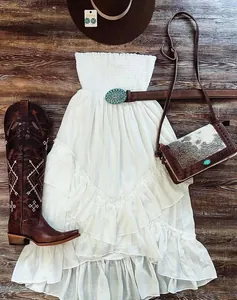 Boho white strapless ruffled tiered beach maxi dress flat lay with western accessories
