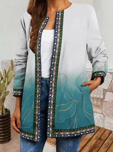 Detail view of retro ethnic print cardigan with gradient teal and white colors.
