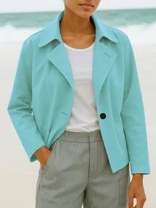 Detail shot of a women's light blue casual short blazer with lapels and single button.
