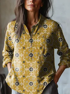 Close-up of mustard yellow floral long-sleeve blouse with button pocket detail.