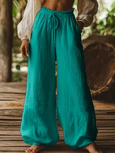 Casual wide-leg trousers with drawstring elastic waist and side pockets in teal color