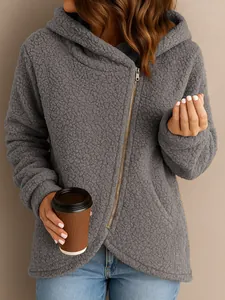 Close-up of women's grey teddy fleece hooded jacket with asymmetrical zipper detail.