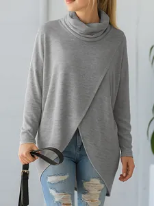 Detail view of grey loose cowl neck knitted top with asymmetrical wrap front design.