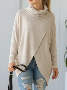 Close-up of beige cowl neck knit top with stylish overlapping front and loose long sleeves