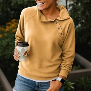 Stylish mustard yellow long sleeve sweatshirt with unique diagonal button collar.