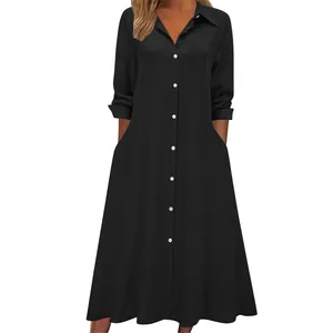 Front view detail of a comfortable loose black long sleeve shirt dress with pockets and collar