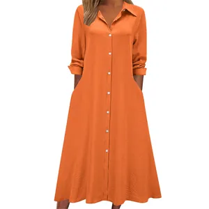 Detail showing the front view of an orange long sleeve shirt dress with pocket details.