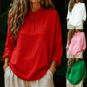 Detail view of women's casual loose long-sleeved shirt in red, white, pink and green.
