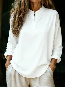 Detailed view of a loose white long-sleeve henley shirt for women with soft texture.