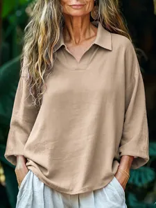 Close-up detail of women's casual loose khaki long-sleeved polo shirt with lapel collar