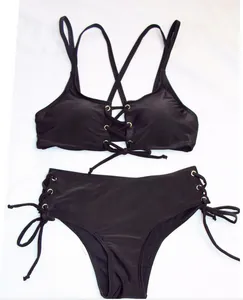 Close-up detail of black two-piece lace-up bikini set featuring sexy hollow-out design.