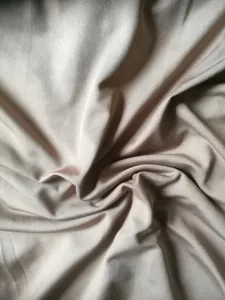 High-quality close-up showing the elegant texture of champagne ribbed fabric for a dress