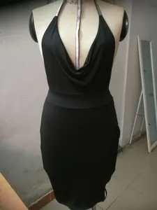 Detailed view of a sexy black halter bodycon dress with a deep V-neck on a mannequin
