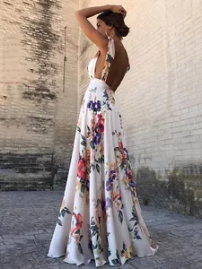 Elegant backless bohemian floral maxi dress with halter neck and large flowing skirt