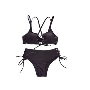 Elegant black two-piece bikini set with lace-up details and high-waisted bottoms