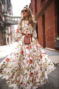 Elegant bohemian floral print maxi dress featuring a stylish waist belt and a mini pouch bag