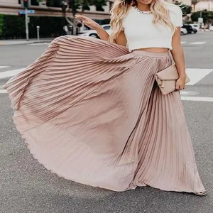 Elegant dusty rose pleated maxi skirt with flowing fabric in an urban street setting