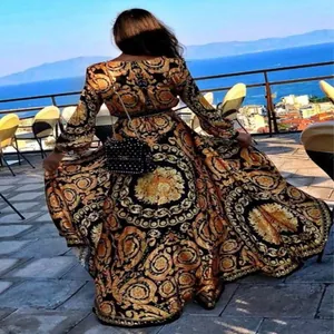 Elegant vintage baroque print long-sleeve maxi dress with a scenic sea view background