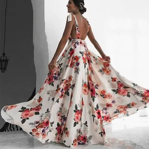 Backless bohemian floral maxi dress with thin straps and a flowing large swing skirt.