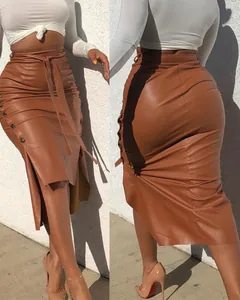 Detailed view of an elegant brown PU leather midi skirt featuring side slit and tie belt