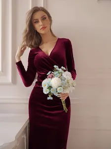 Detail view of burgundy velvet evening dress with elegant V-neck and slim fit design.