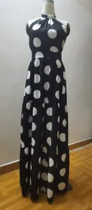 Elegant black and white polka dot halter maxi dress with flared tiered hem for women