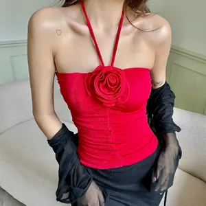 Detail of red halter top featuring a large 3D rose flower decoration on chest.