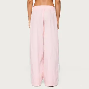 Back view of premium women's loose pink drawstring pants with white side stripes