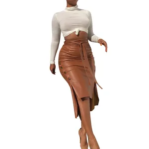 Elegant women's brown PU leather midi skirt featuring side slit and decorative studs