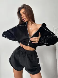 Chic black velvet two-piece set featuring a zip-up cropped jacket and high-waist shorts
