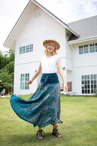 Flowing bohemian peacock print maxi skirt with high-waisted tie-front design on lawn