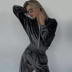 Chic dark grey velvet tracksuit set featuring a zip-up cropped hoodie and high-waist pants