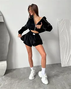 Detail of black velvet two-piece tracksuit with zip-up hoodie and high-waist shorts