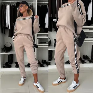 Casual women's beige two-piece tracksuit set featuring sporty black and white side stripes