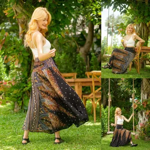 Bohemian printed long maxi skirt shown in a lush garden setting on a swing outdoors