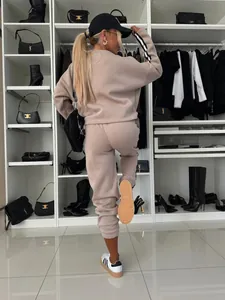 Back view of a casual two-piece sweatsuit featuring side-striped sleeves and joggers