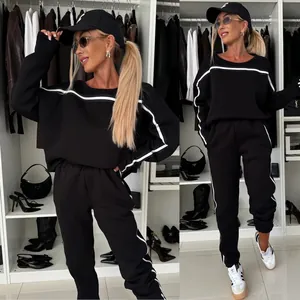 Fashionable two-piece black sweatshirt and jogger set featuring stylish white side stripe detail