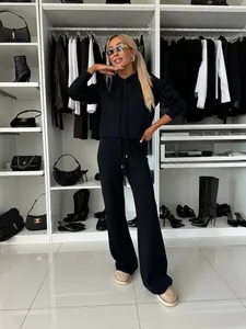 Ensemble deux pièces noir en tricot avec sweat à capuche et pantalon large dans un dressing chic