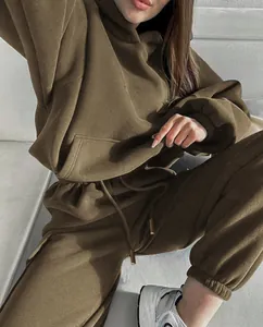 Close-up view of olive green two-piece tracksuit with cozy hoodie and jogger pants.