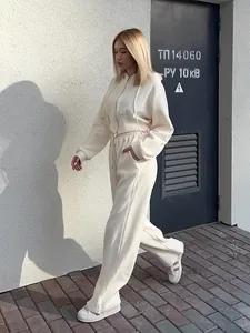 Detail of a cream women's two-piece hoodie and drawstring pants leisure set.