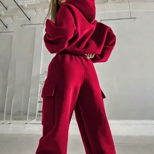 Back view of a women's vibrant red oversized hoodie and cargo sweatpants leisure set