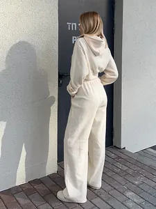 Back view of a two-piece cream leisure tracksuit with a cropped hoodie and wide-leg pants
