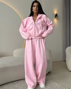 Stylish women's pink two-piece tracksuit set featuring zip-up hoodie and wide-leg pants