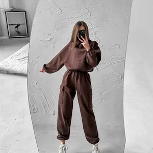 Mirror selfie of a woman wearing a chocolate brown oversized hoodie and cargo joggers set