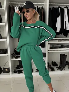 Casual green women's two-piece tracksuit featuring striped sweatshirt and joggers set