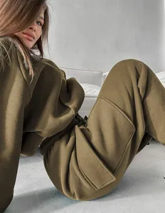 Detailed view of women's olive green autumn cargo tracksuit with large side pockets