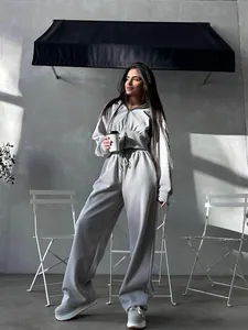 Detailed view of women's gray two-piece tracksuit set with hoodie and wide-leg pants