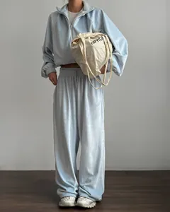 Detailed view of the soft light blue velvet texture on a casual two-piece tracksuit.